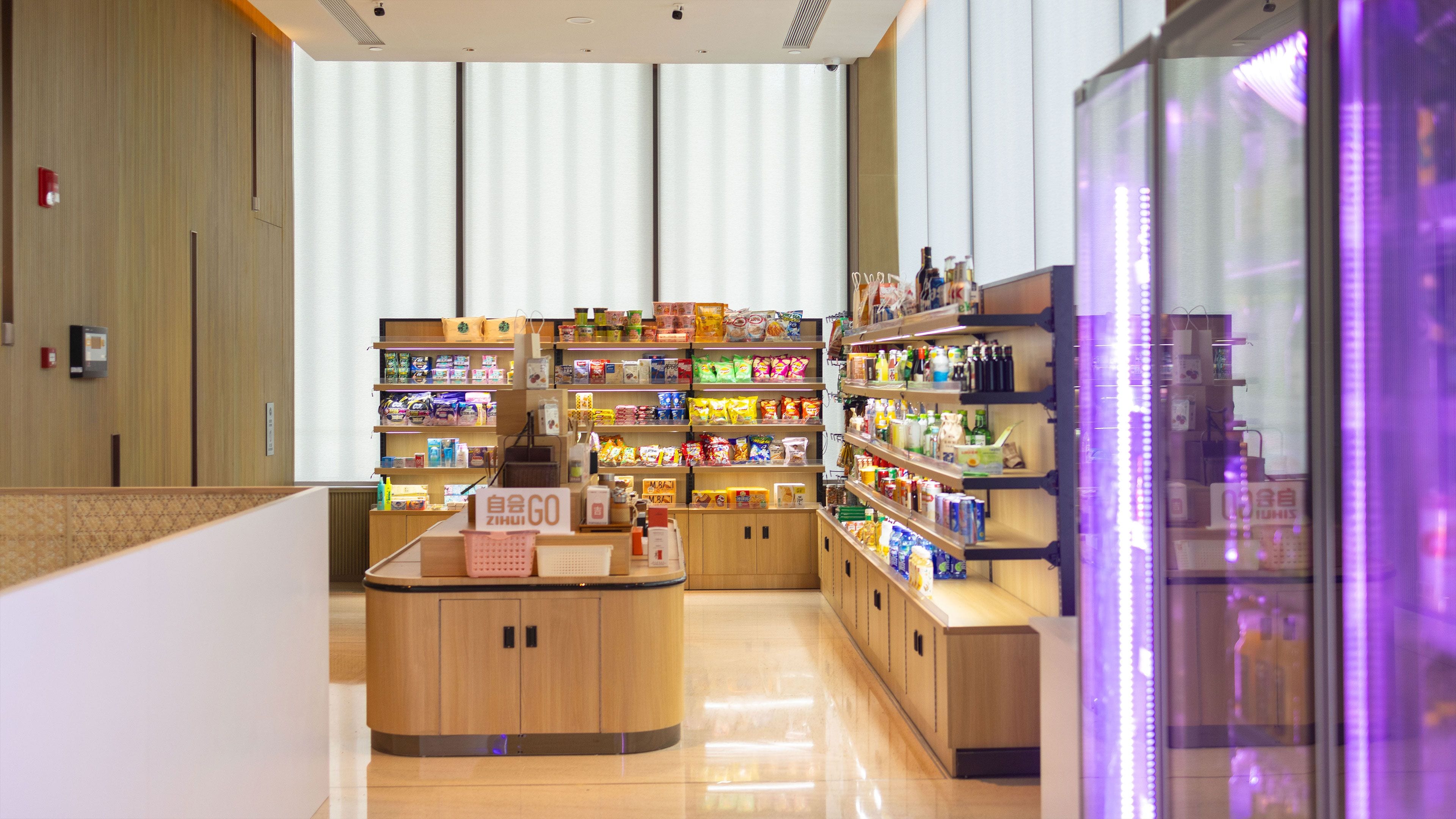 A modern retail store with wooden counters and shelves stocked with various products.