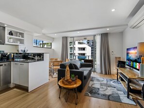 A modern apartment with a kitchen, living area, and balcony.