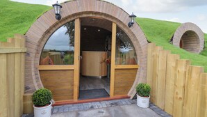 A wooden structure with a semi-circular archway leading to an interior space. - Tan Y Wawr - Derwen (Welshpool)