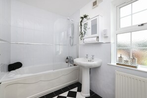 A modern bathroom with a freestanding bathtub, a pedestal sink, and a window with a view. - JOIVY Greenknowes Lodge With Hot Tub And Wood Burning Stove (Kelty)