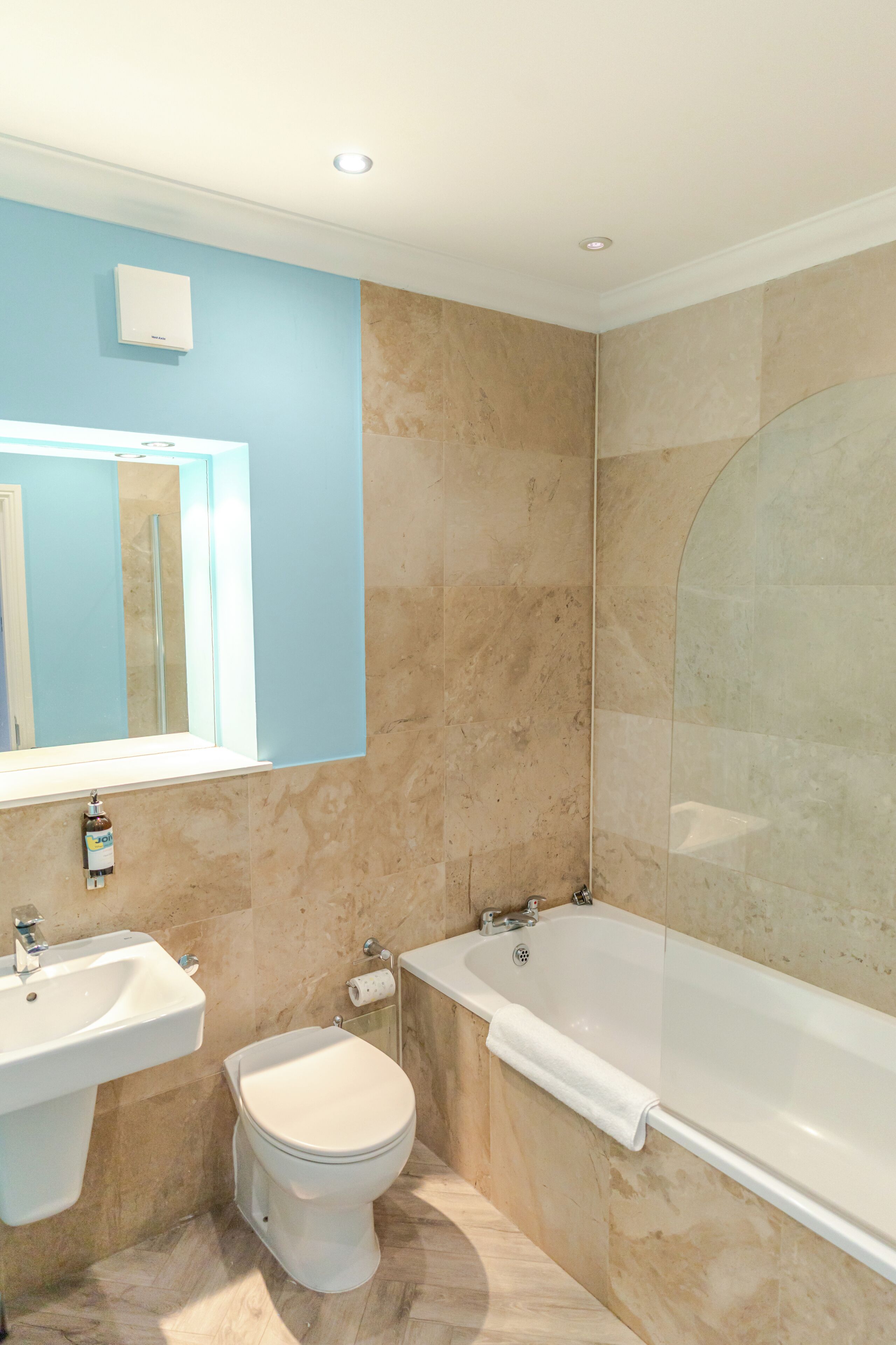 A bathroom with a sink, toilet, and bathtub.