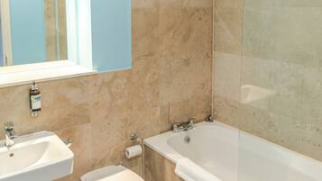 A bathroom with a sink, toilet, and bathtub.