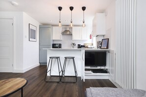 Apartment, 1 Bedroom, Balcony | Living area | TV