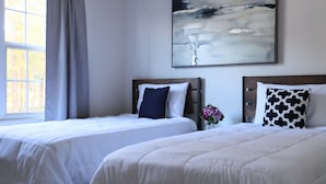 Two beds with white bedding, a window with a view, and a painting on the wall. - Spacious, Relaxed 5 Bedroom Getaway (LILBURN)