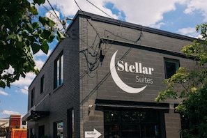 A building with a sign for 'Stellar Suites' featuring a crescent moon logo.