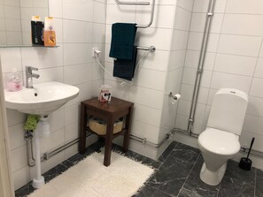 Bathroom features a sink, toilet, and towel rack.