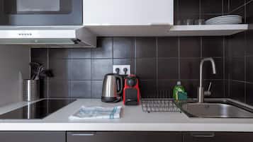A modern kitchen with a microwave, kettle, and coffee maker.