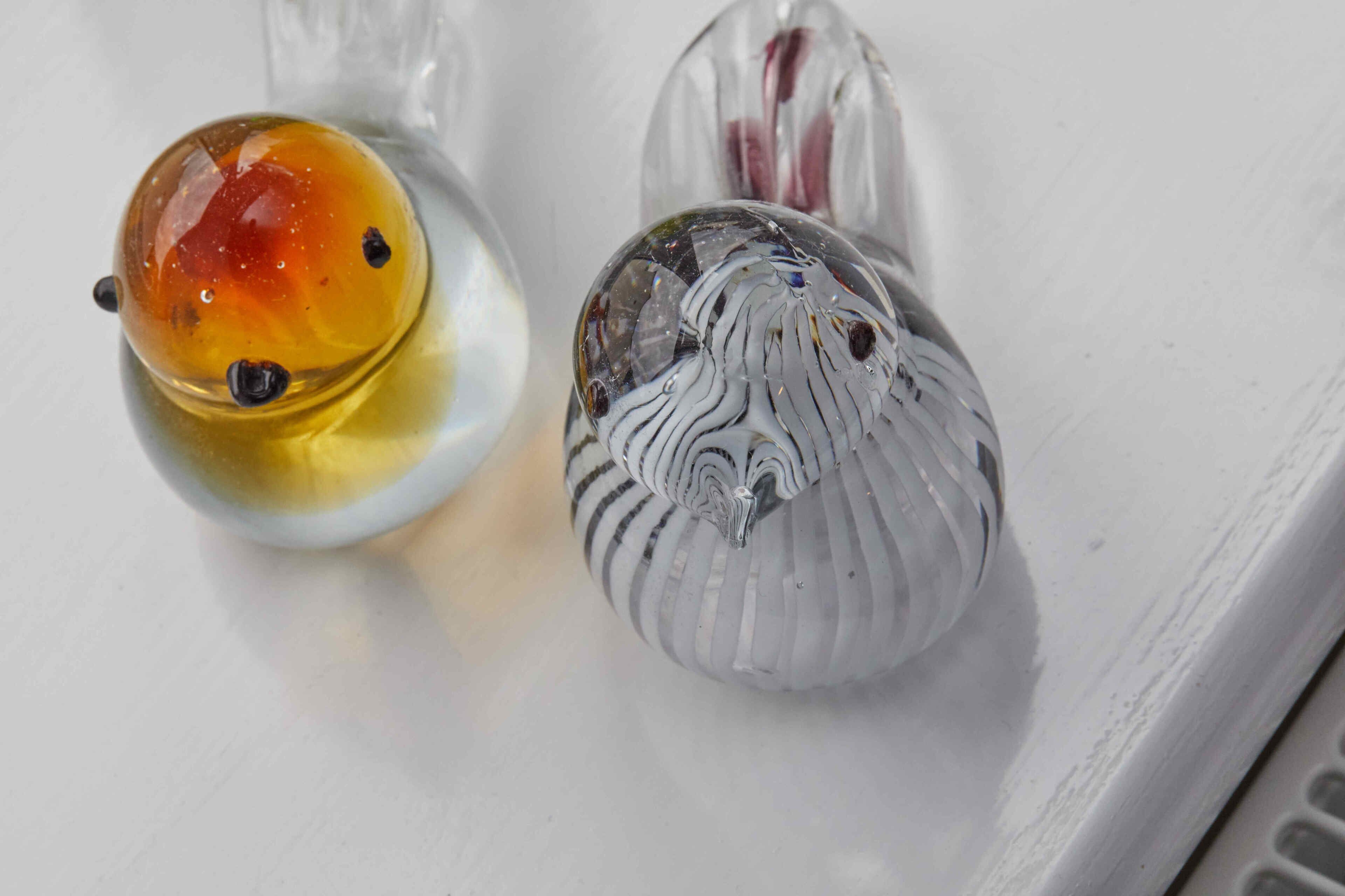 Two salt and pepper shakers on a white surface.