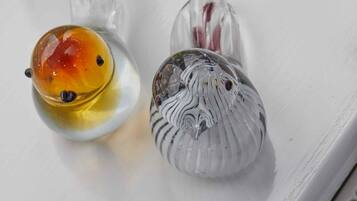 Two salt and pepper shakers on a white surface.