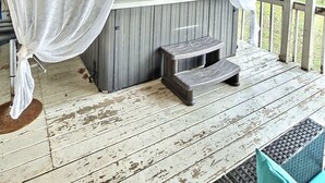 A hot tub with a canopy, a VIP lounge sign, and a wooden deck. - Serene Lakefront Cottage Escape (Rivière-Rouge)
