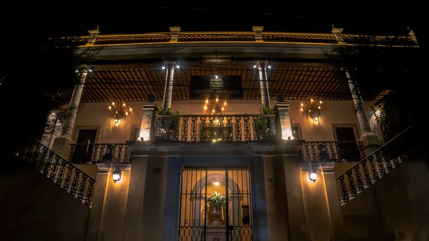A historic building with a central entrance, ornate iron railings, and a sign indicating it is a Mexican restaurant. - Hotel Boutique Corazón Mexicano (Guanajuato)