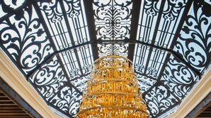 A grand atrium with a large, ornate chandelier and a high ceiling with intricate black and white patterns. - Hotel Boutique Corazón Mexicano (Guanajuato)