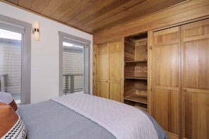 A bedroom with a bed, wooden wardrobe, and a window with blinds. - 2 Bedroom With Loft Located in Big Sky Resort Area (Big Sky)
