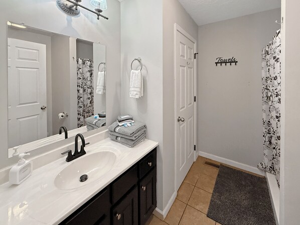 Bathtub, hair dryer, towels, soap