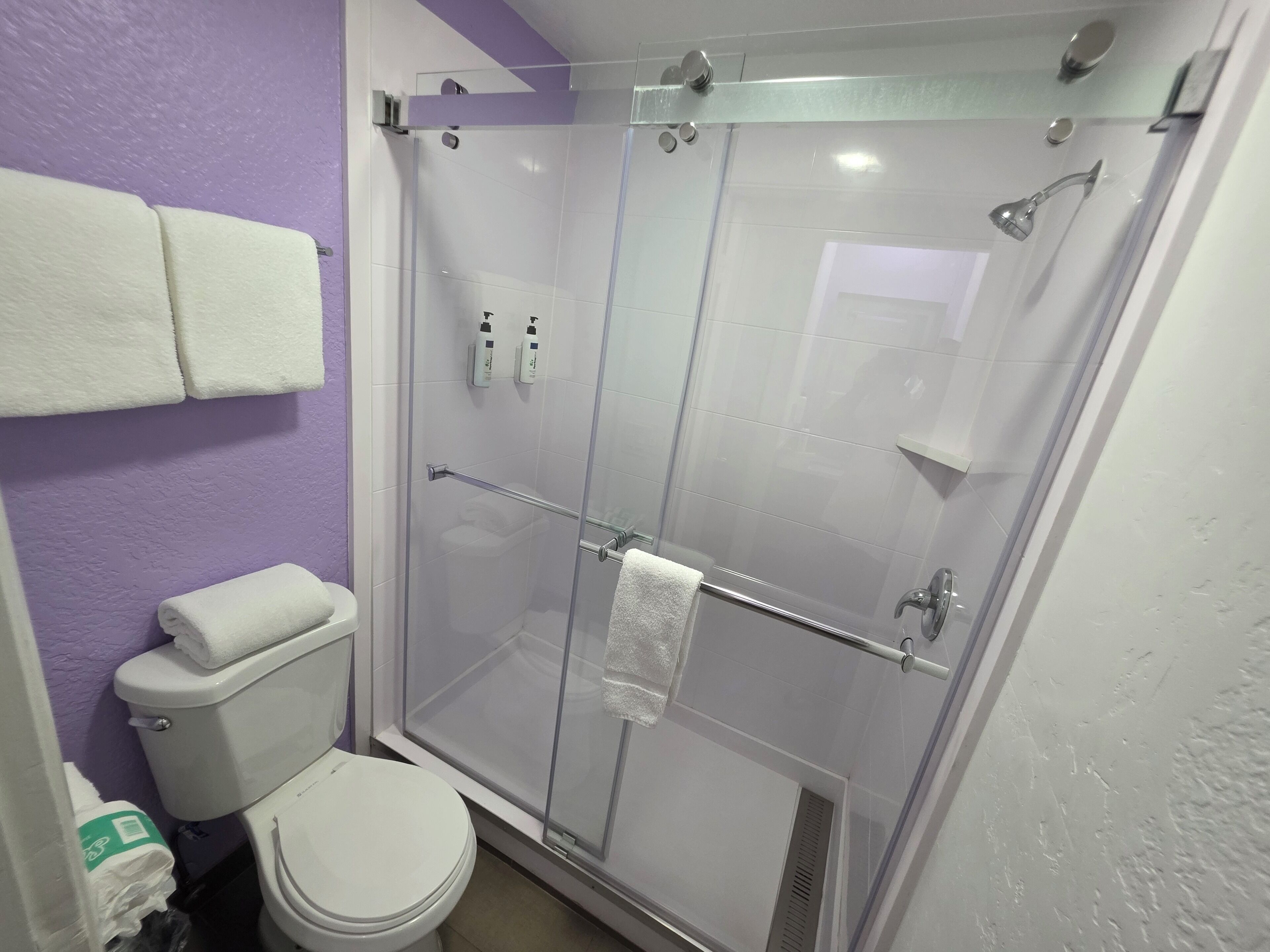 shower, designer toiletries, hair dryer, towels