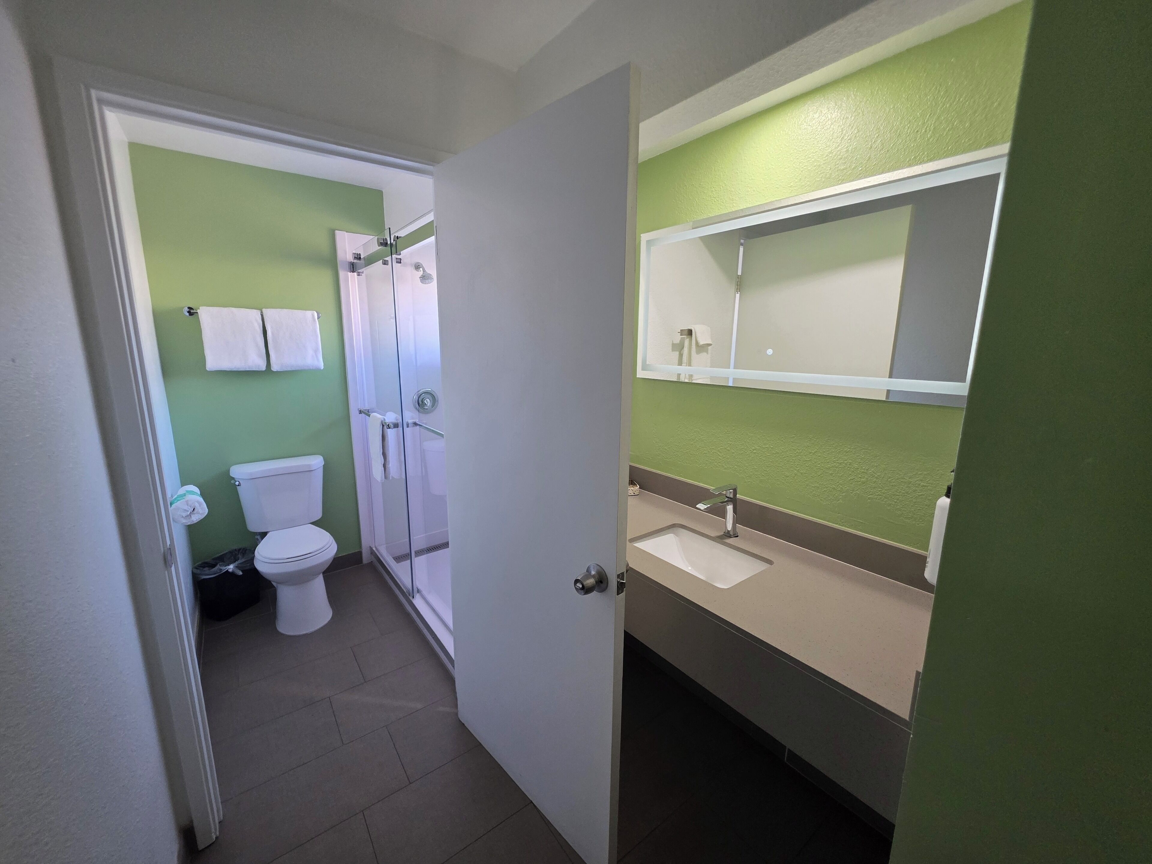 deluxe room 1 king bed | bathroom | shower, designer toiletries, hair dryer, towels