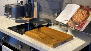 A kitchen with a modern stove, a toaster, and a cookbook on the counter. - Great for exploring North Yorkshire (Easingwold)