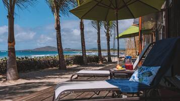 On the beach, white sand, free beach cabanas, sun loungers