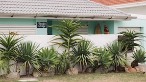 A building with a sign reading "Pacific Lodge" and a surfboard decoration.