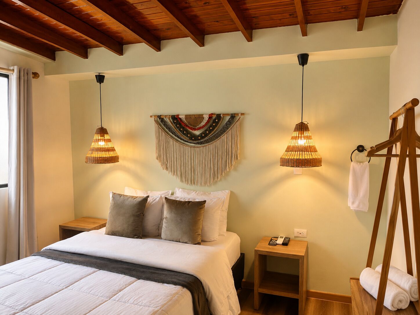 A bedroom with a bed, bedside tables, a hanging light fixture, and a wooden headboard.