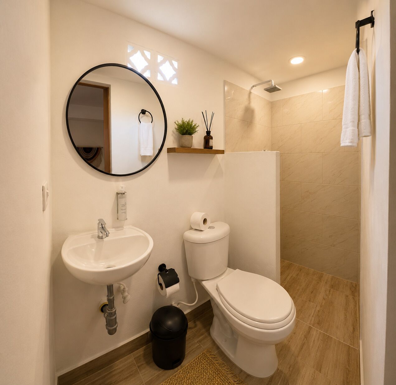 A modern bathroom with a sink, toilet, and shower.