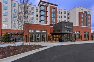 A multi-story hotel with a modern design, featuring a prominent 'Residence Inn by Marriott' sign.