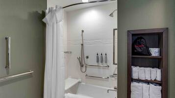 A bathroom with a bathtub, shower, and towel rack.
