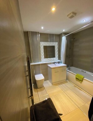 Combined shower/tub, hair dryer, towels, soap