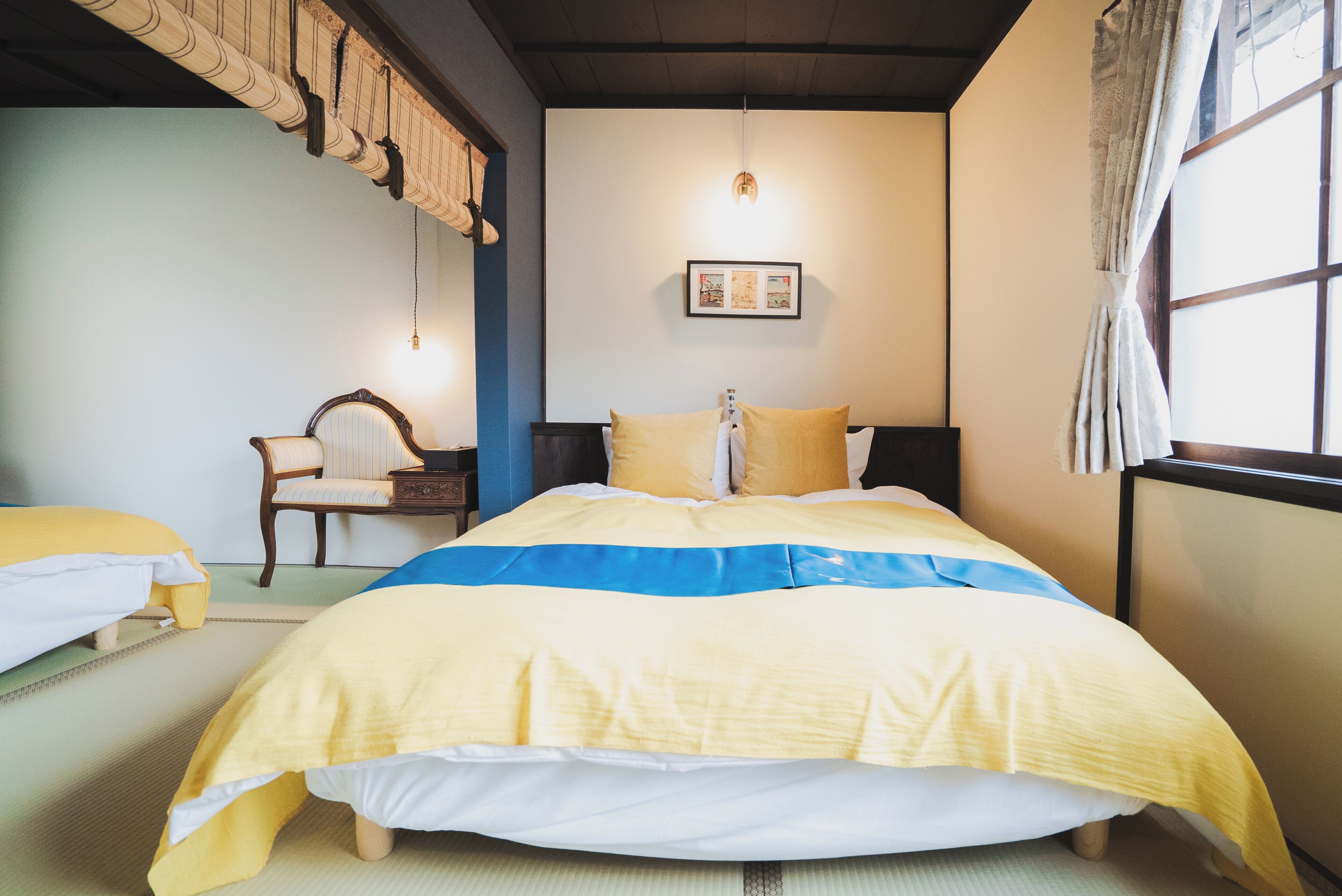 A neatly arranged bedroom with a bed, a chair, and a bedside table.