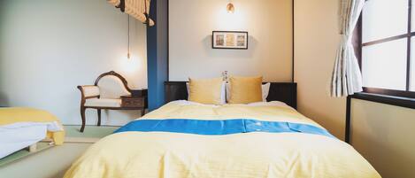 A neatly arranged bedroom with a bed, a chair, and a bedside table.