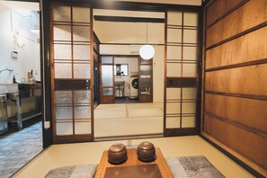 Experience traditional Japanese simplicity in this serene room with tatami flooring and shoji screens.