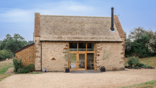 A stone building with a tiled roof, a chimney, and a large glass door. - Spring Barn, Chipping Norton - sleeps 4 guests  in 2 bedrooms (Great Rollright)