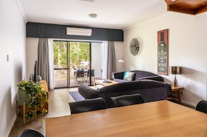 Relax in this inviting living area with a sofa, dining table, and outdoor access.