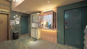 A reception area with a counter, a 'STAFF ONLY' door, and a 'INFORMATION' sign. - February Hotel The Stay Gangseo Main Building (Busan)