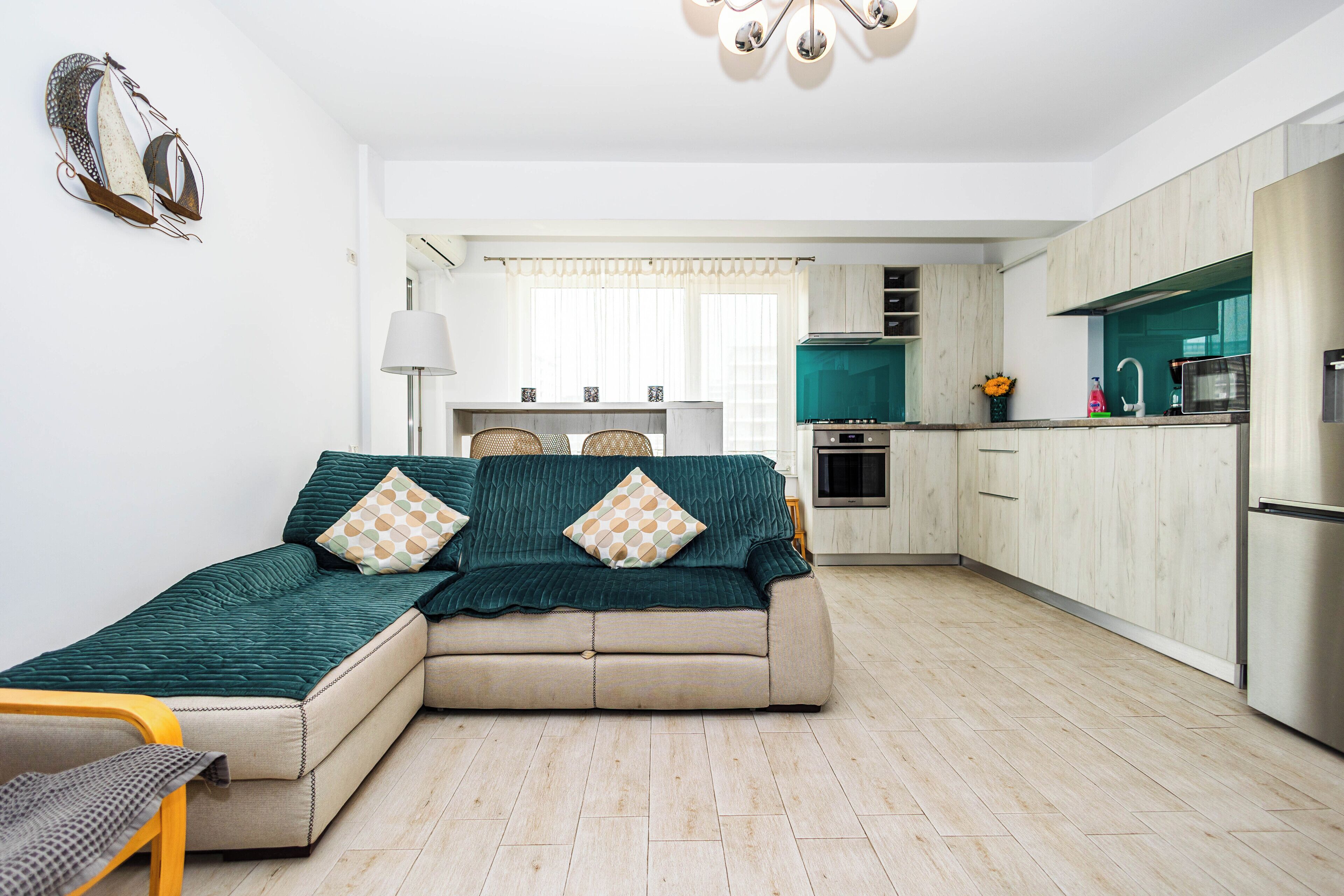 A modern living room with a sofa and a dining area.