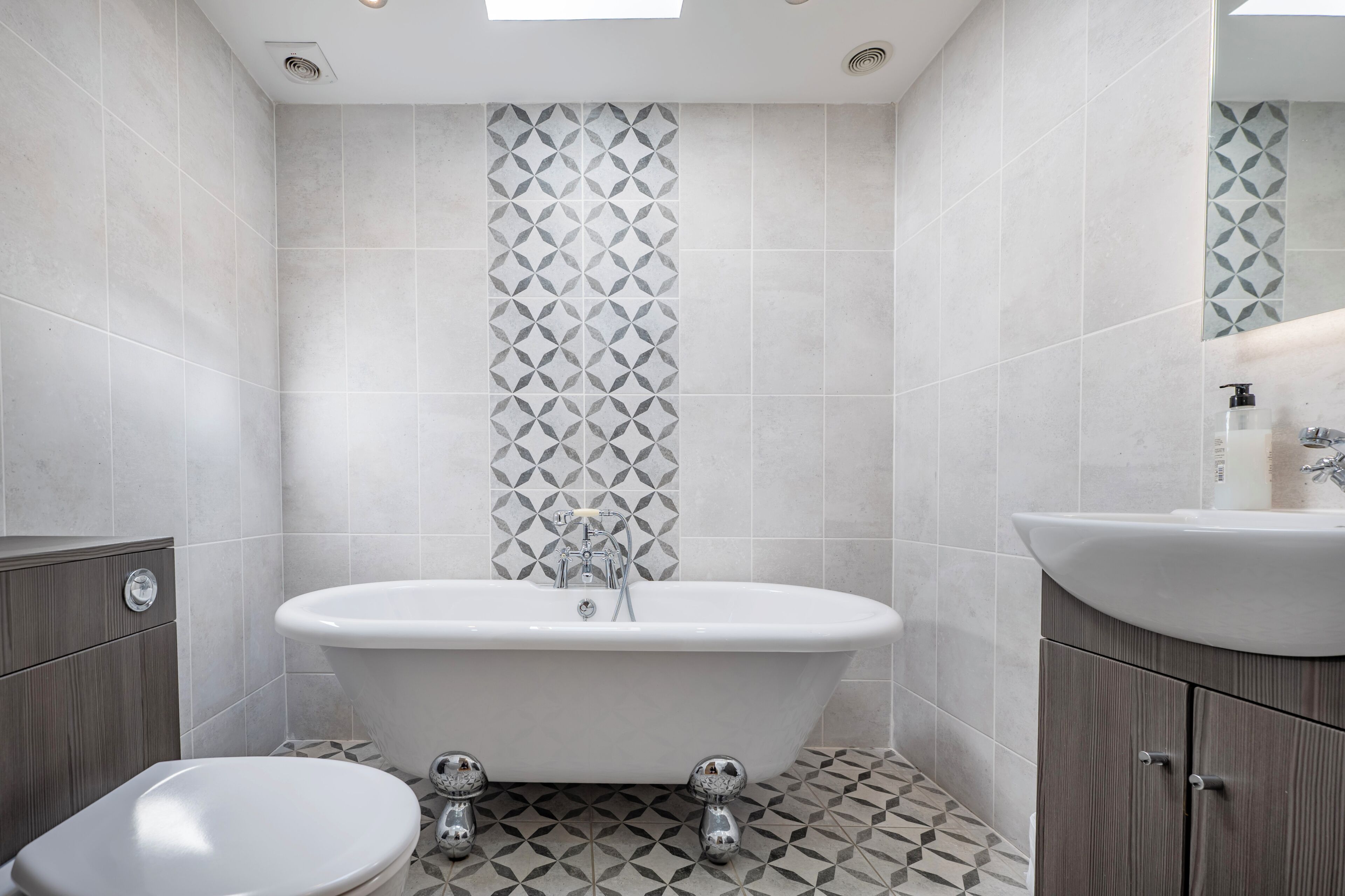 A bathroom with a freestanding bathtub, a toilet, and a sink.