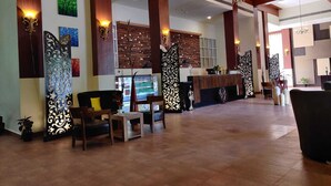 A spacious lobby with high ceilings, wooden beams, and a reception desk. - The Grand Neelam Hotel (Raipur)