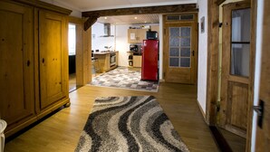 A spacious kitchen with wooden cabinets, a red refrigerator, and a checkered floor mat. - Spacious 6-person gîte in Kaysersberg (Kaysersberg)