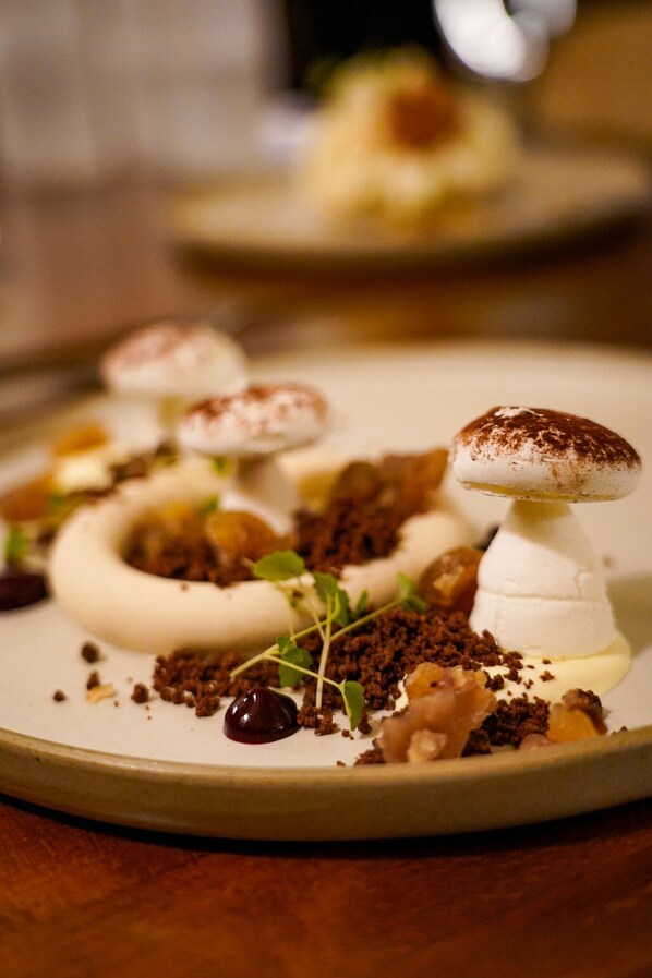 A dessert plate with various toppings and a mushroom.
