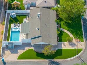 An aerial view of a residential property with a swimming pool, a covered patio, and a well-maintained lawn. - 8 Min to Old Town | 2 Master Suites | Heated Pool | Best Location | Sleeps 10 (Phoenix)