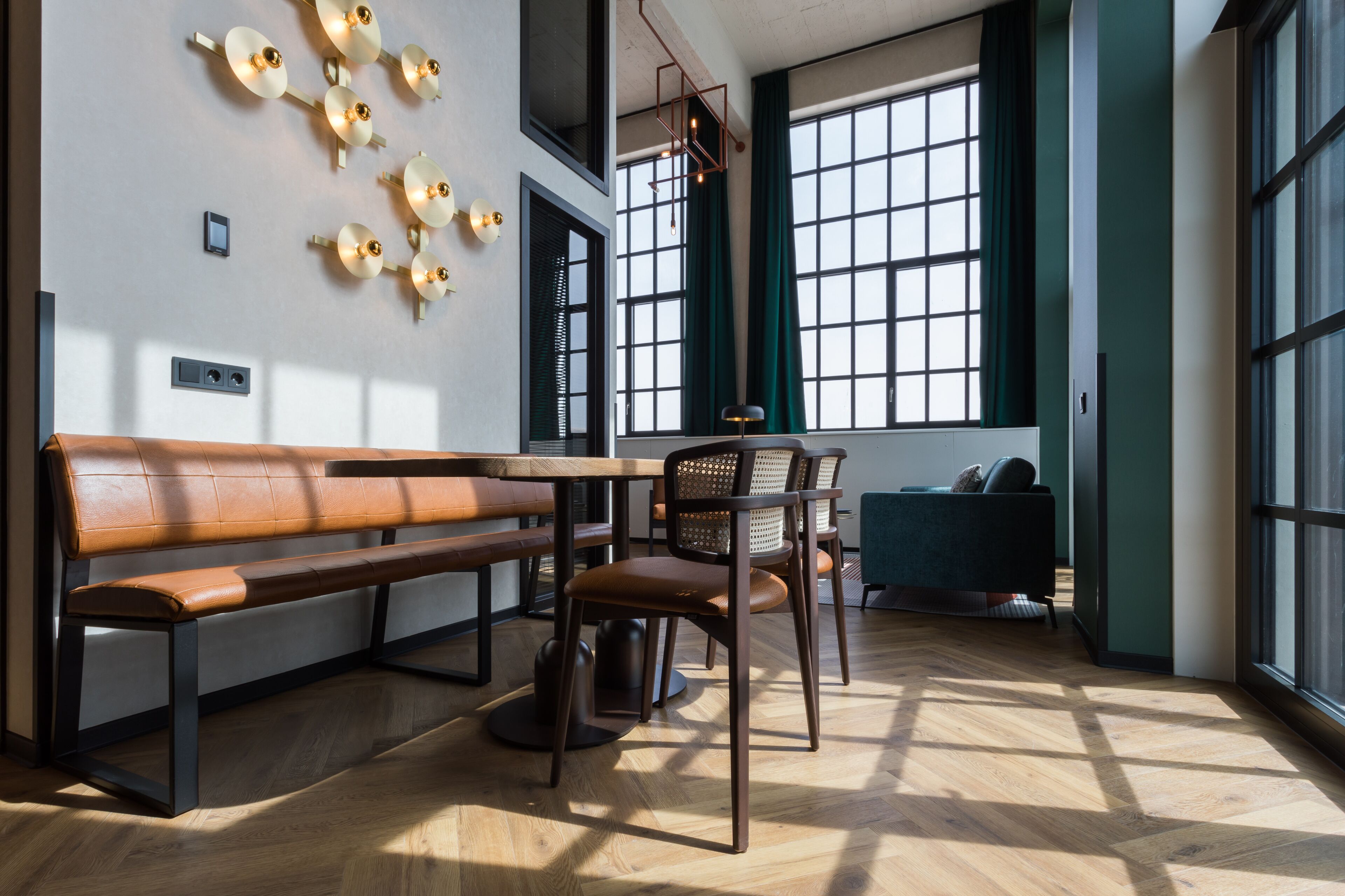 A modern interior with a wooden bench, a dining table, and a chair.