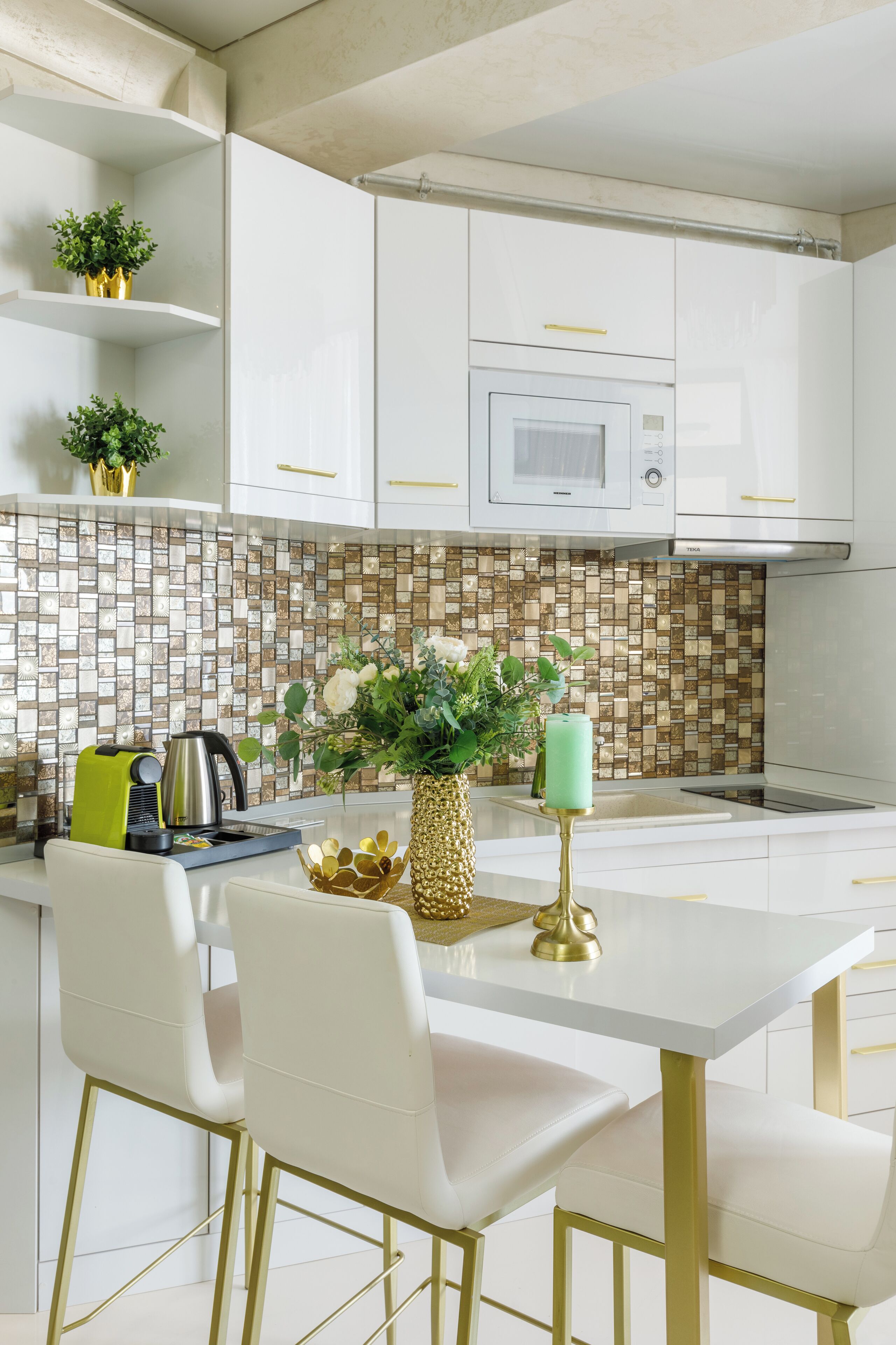 A modern kitchen with white cabinets, a tiled backsplash, and a central island with chairs.