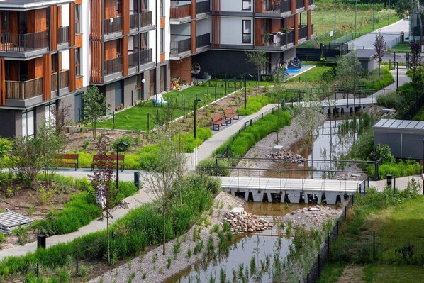 Experience and communal living spaces with a serene garden and water feature.