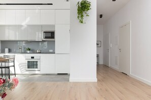 Enjoy meals in this kitchen with a dining table and chairs, microwave, and oven.