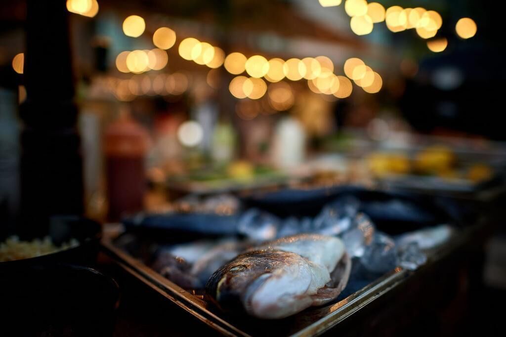 A grill with seafood, likely for outdoor dining.