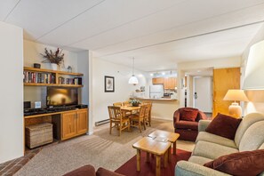 A compact living space with a kitchenette, dining area, and seating area.