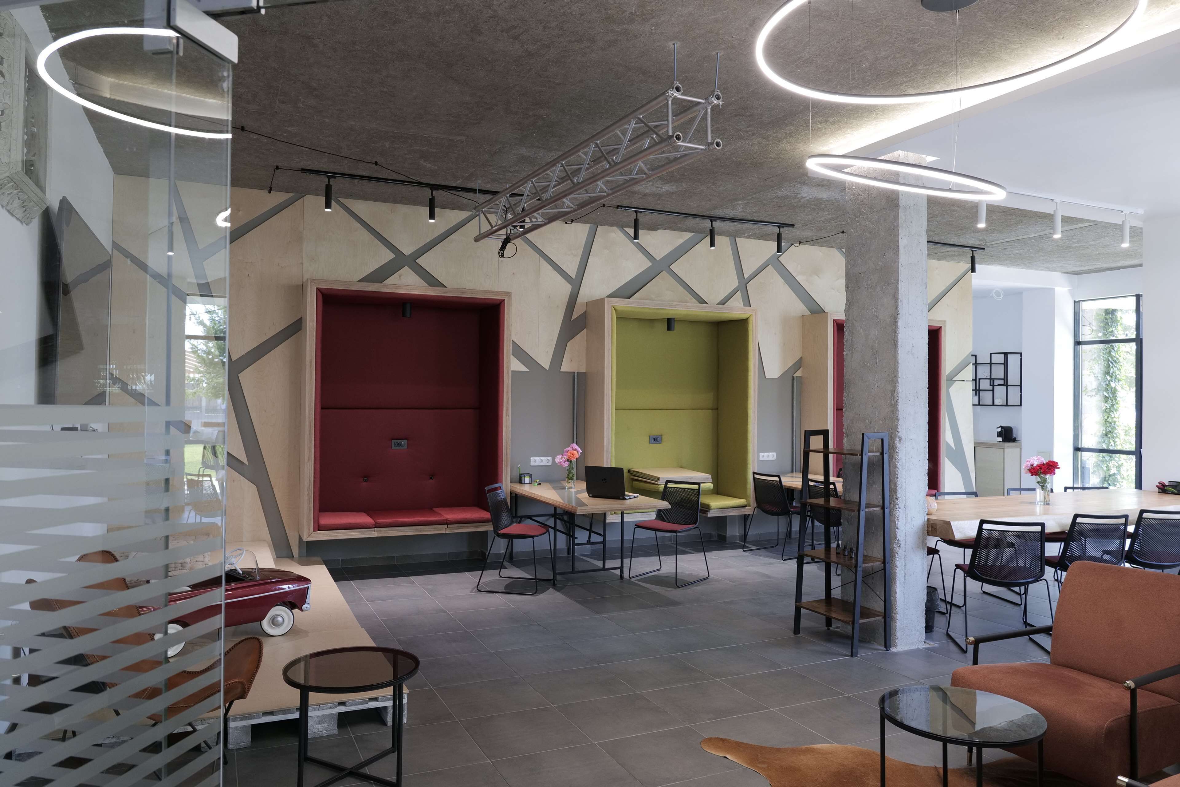 A modern interior with a dining area, seating, and a staircase.