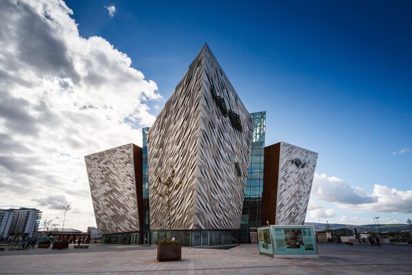 A modern building with a unique angular design and a glass facade.