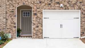 A house with a stone facade, a grey door, and a white garage door. - ❤ of Stonecrest☀1556ft²☀Backyard☀Parking☀W/D (stone crest)