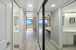 A modern bathroom with a shower, sink, and a view of the outdoors.